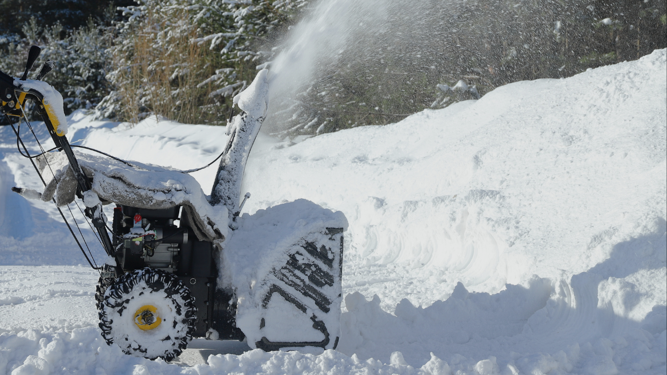 Snow removal equipment clearing a driveway